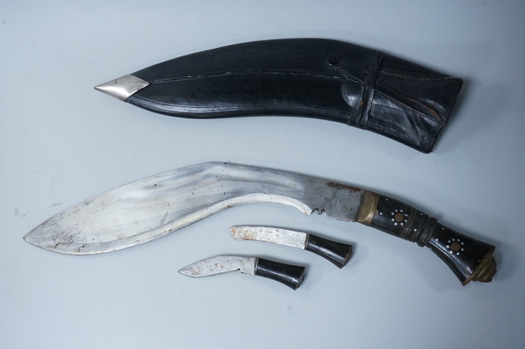 Two kukri knives in leather covered scabbards